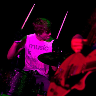 Harry Gilbert drumming on stage